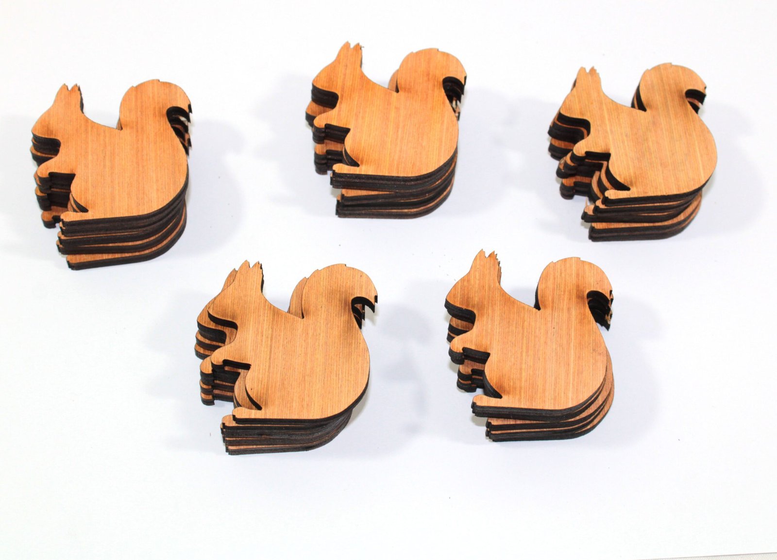 piles of laser cut plywood squirrels