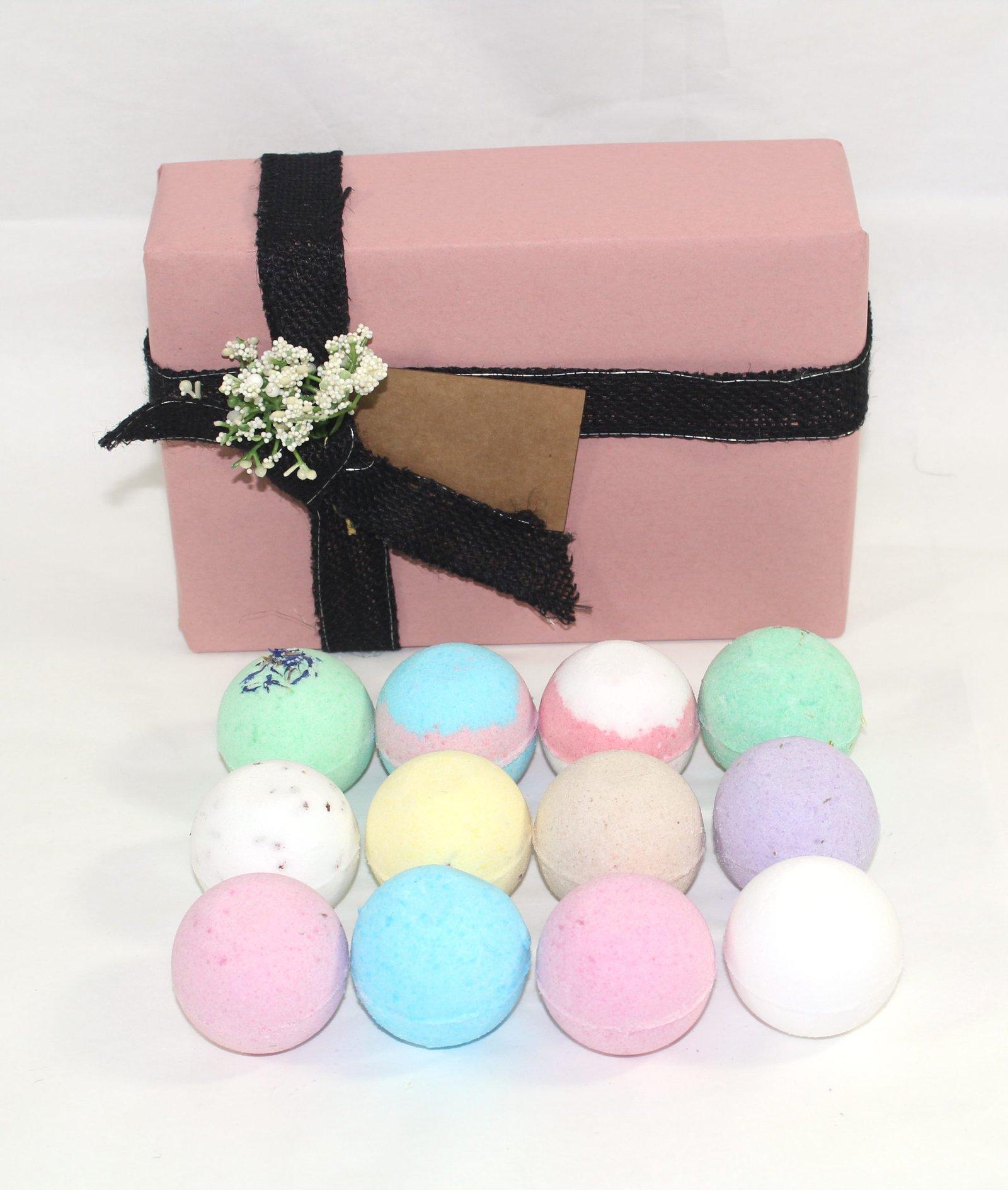 pink gift wrap with tag and bath bombs infront