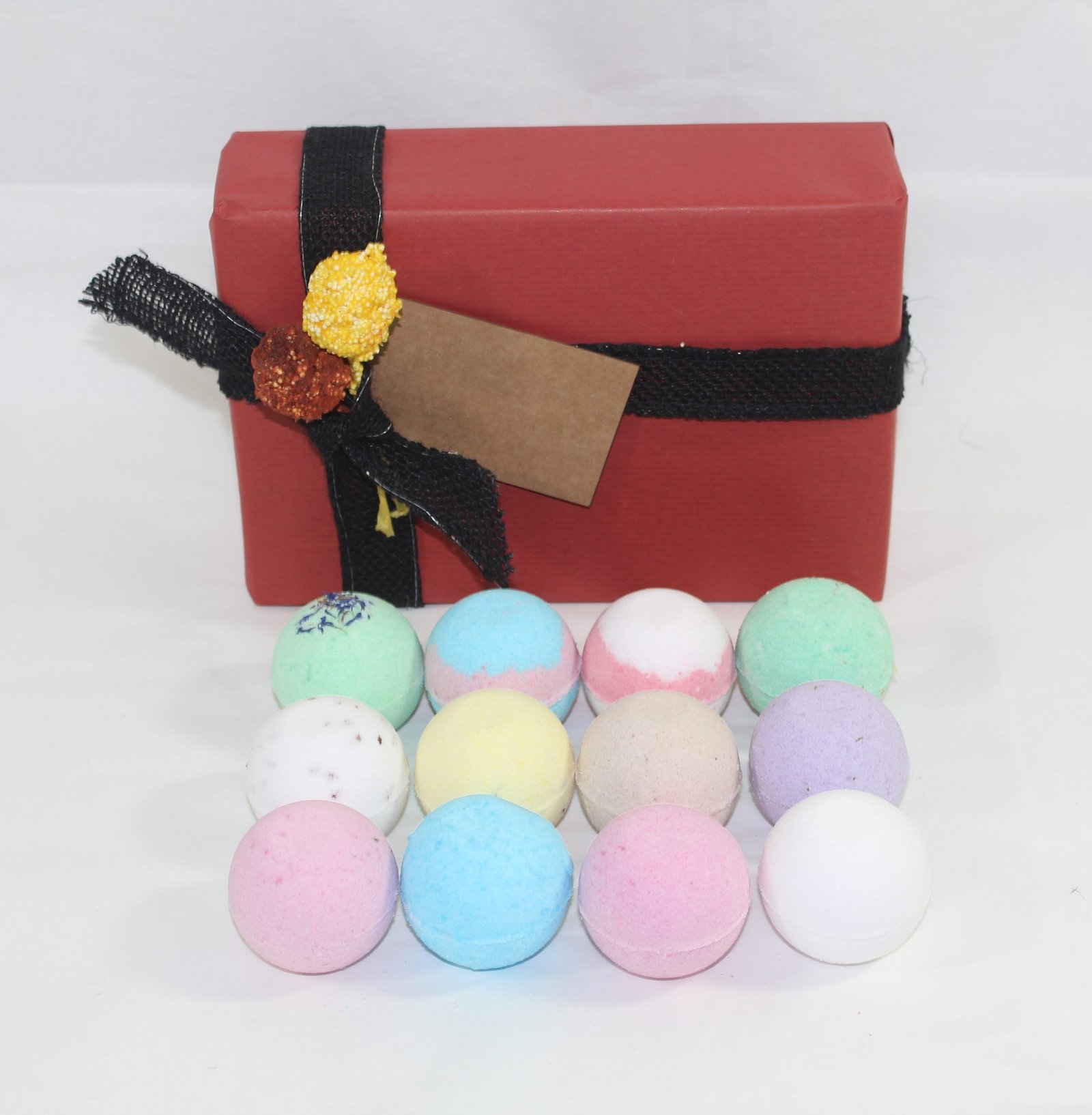 red gift wrap with bath bombs in front